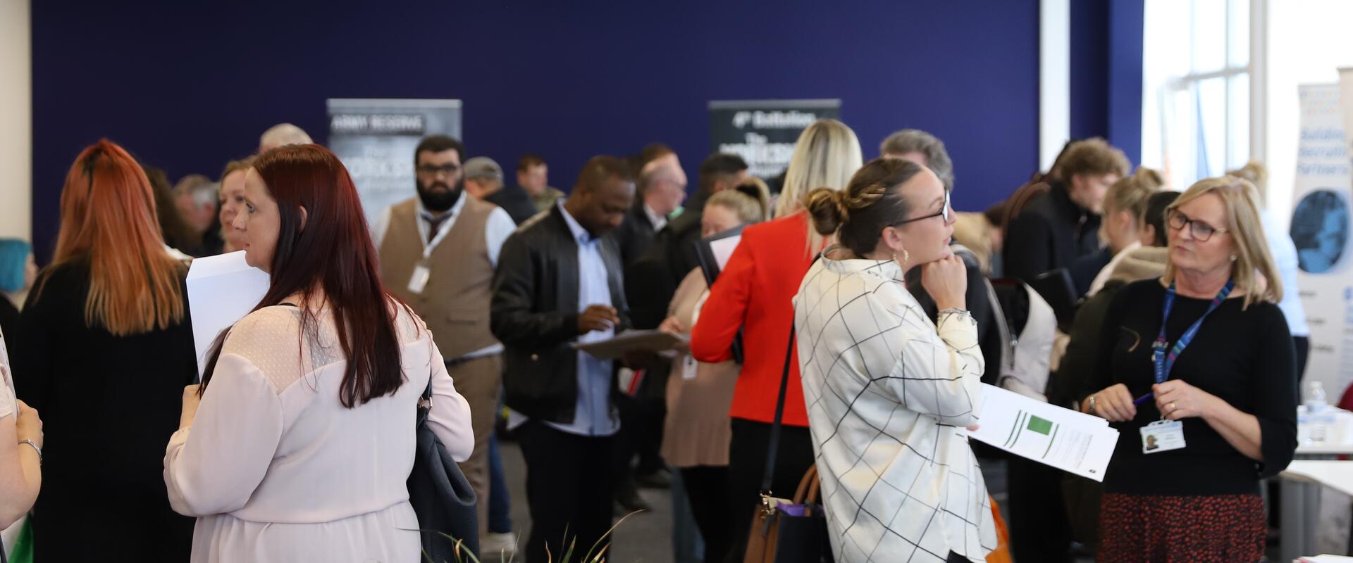 Busy office event. Men and women talking.