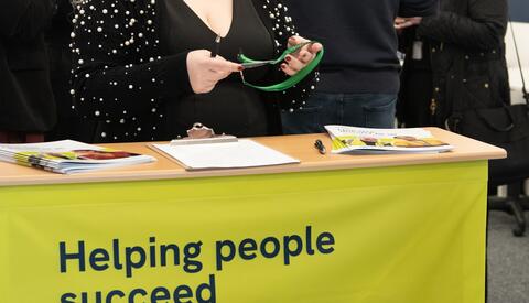 Helping People Succeed sign with a happy smiling woman 