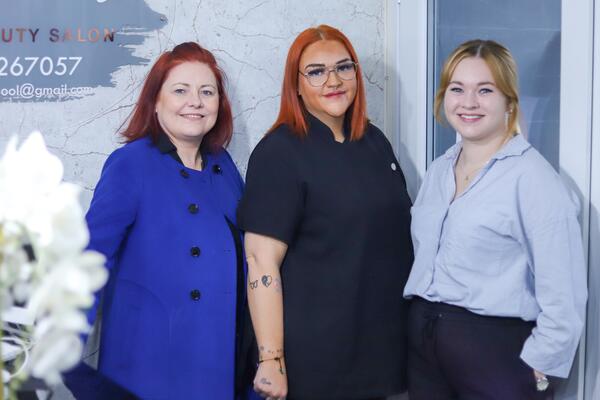 Three women smiling at the camera.