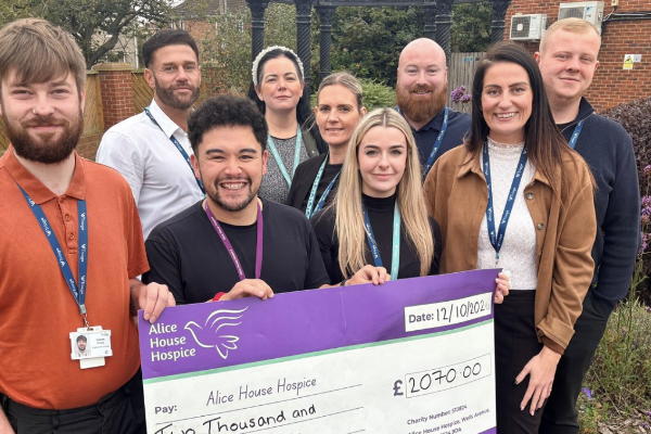 Group of men and woman holding a cheque for £2070 for Alice House Hospice